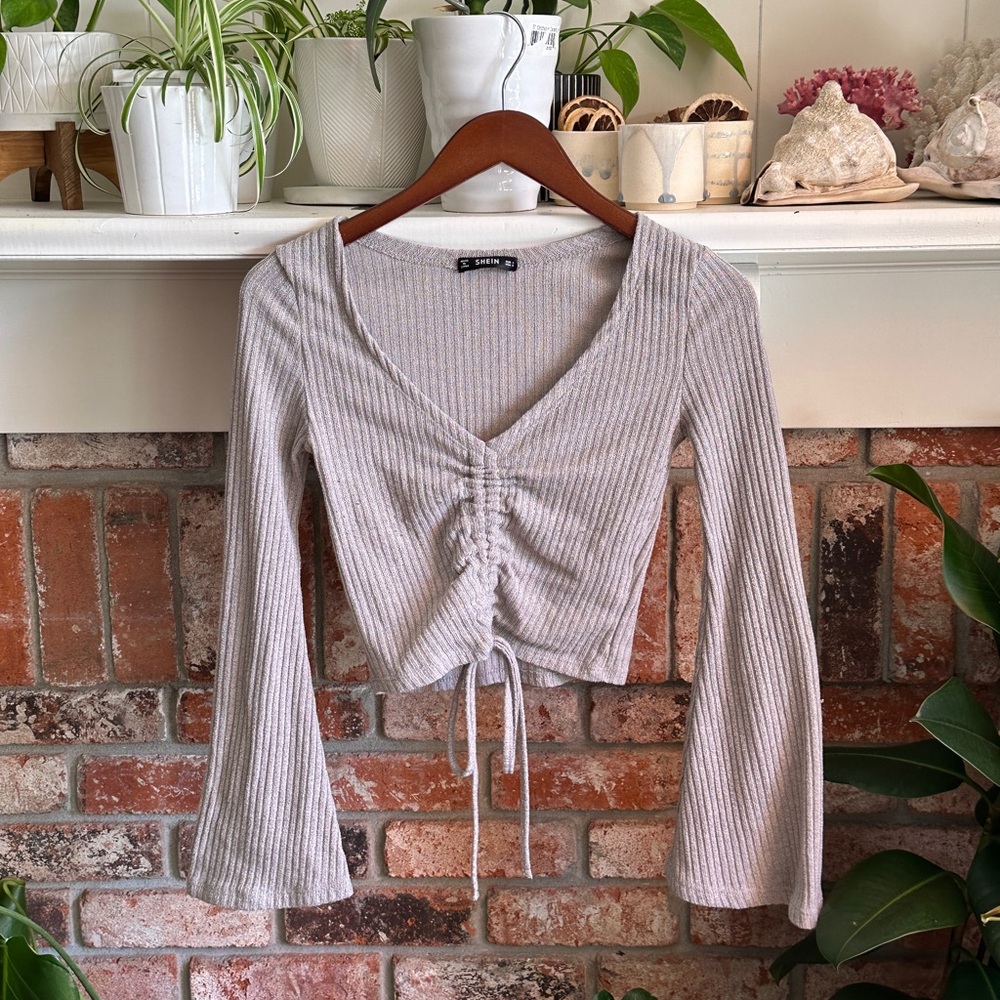 Bell-sleeve crop top long-sleeve with front rouching detail.